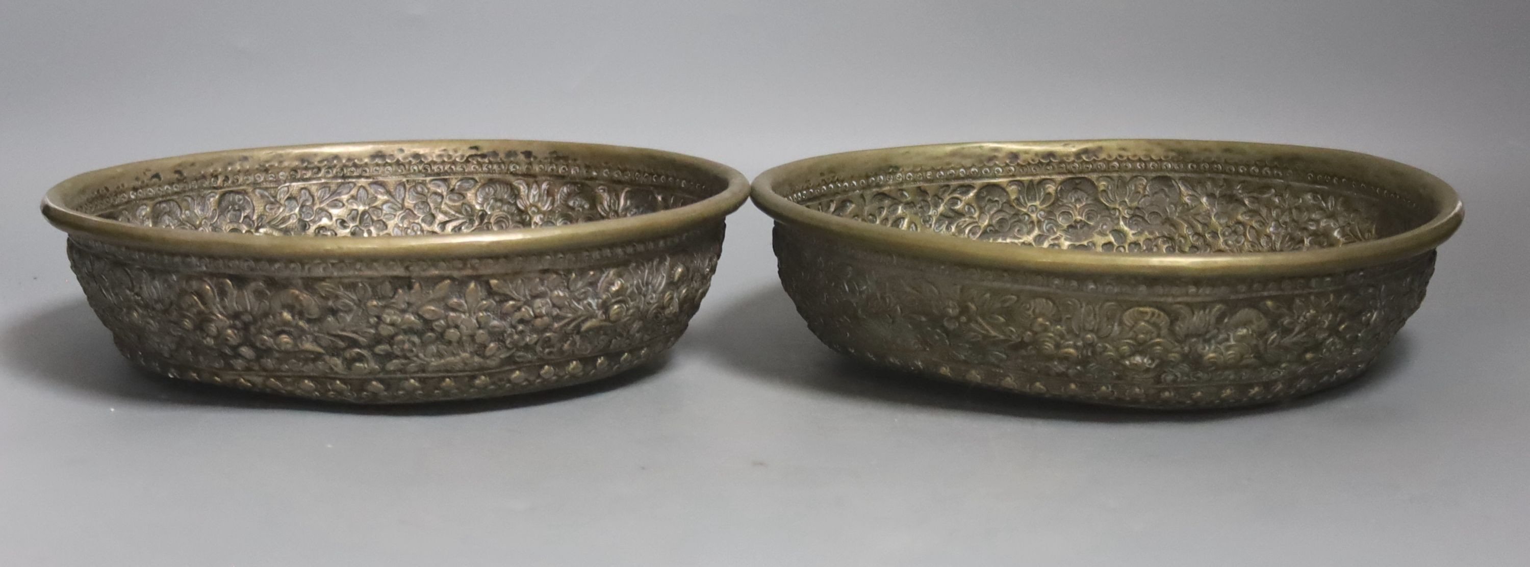A pair of Far Eastern embossed silvered metal circular bowls, Dia 22.5cm